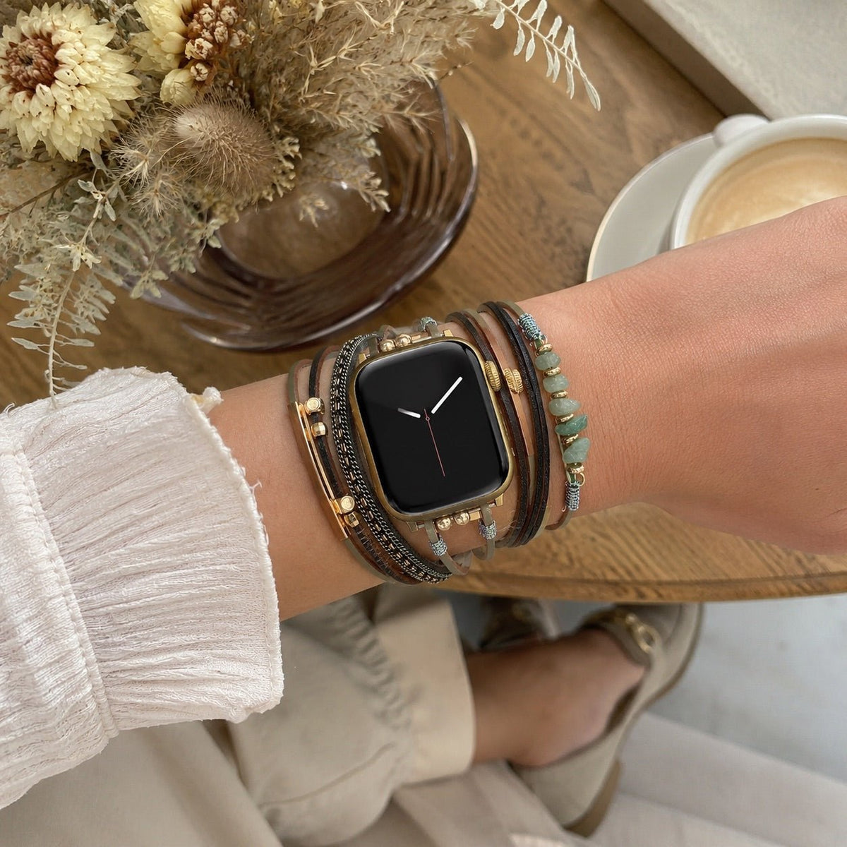 Damen-Uhrenarmband mit mehreren Kordeln, goldenen Details und grünen Steinen, elegantes Handgelenk-Accessoire